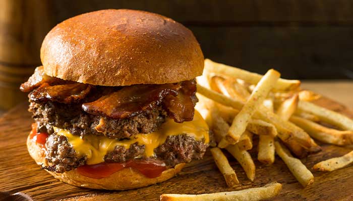 The Lodge of Spring Grove restaurant and bar in Illinois serves double patties smash cheeseburgers topped with bacon